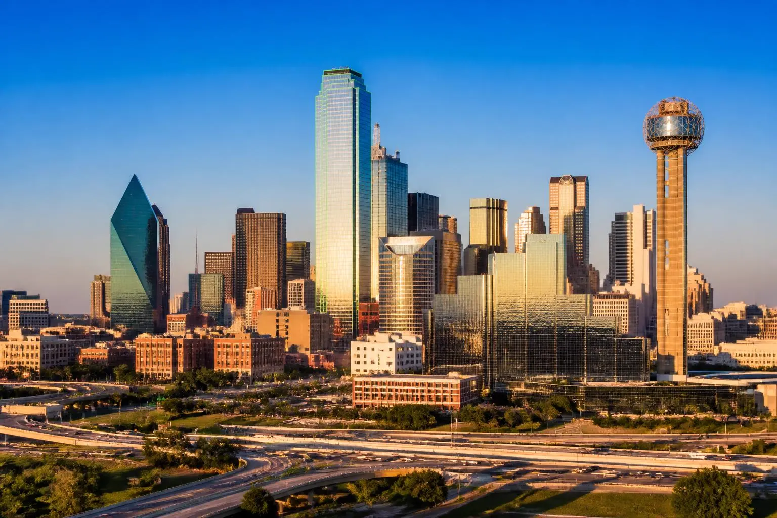 Downtown Dallas skyline at golden hour, proudly served by Elite Odor Removal